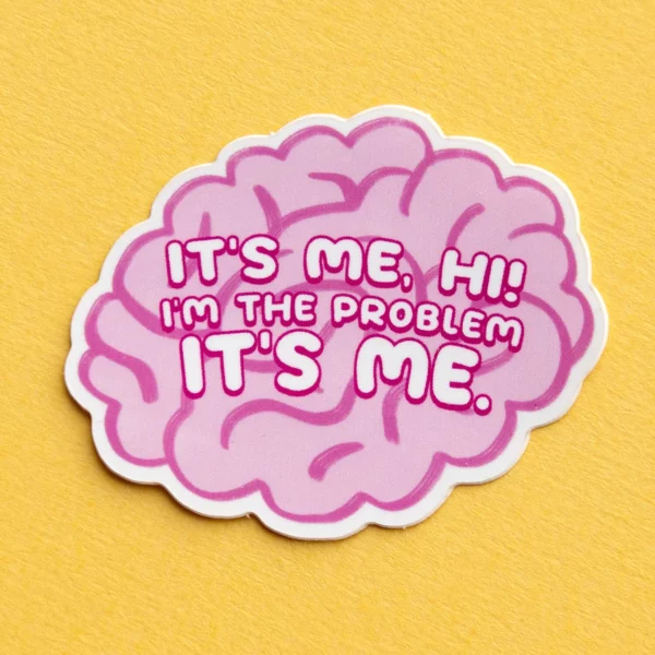 Rozekleurige sticker in de vorm van hersenen, met daarop de tekst it's me, hi, i'm the problem it's me